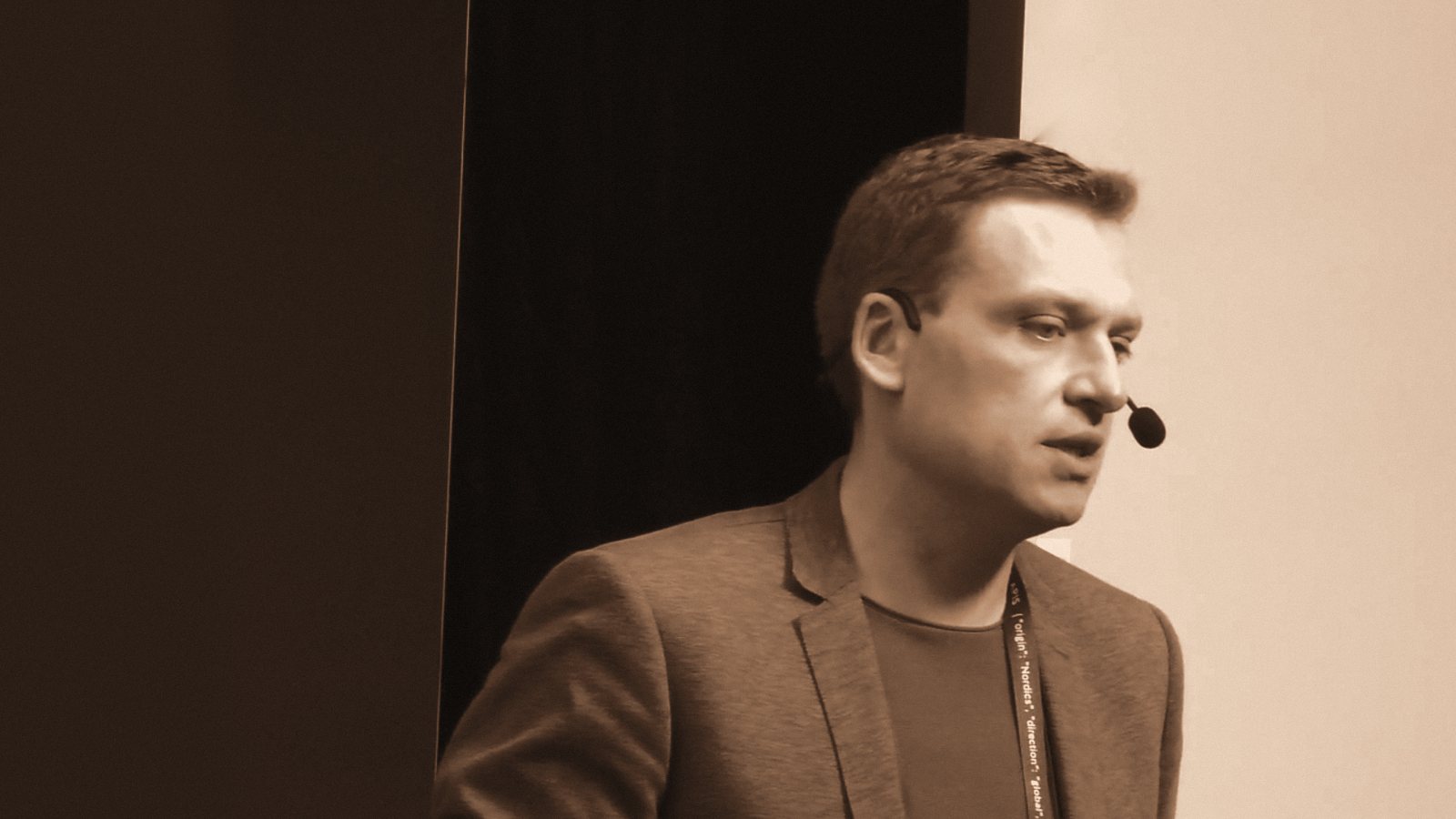 Ivan Nokhrin on stage at Platform Summit, speaking with a headset microphone